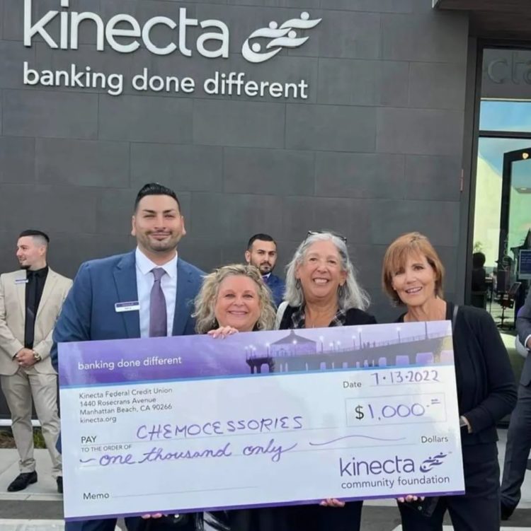 Iris Lee Knell and members of the Chemocessories Board accept a $1,000 check from Kinecta bank at its Manhattan Beach ribbon cutting ceremony